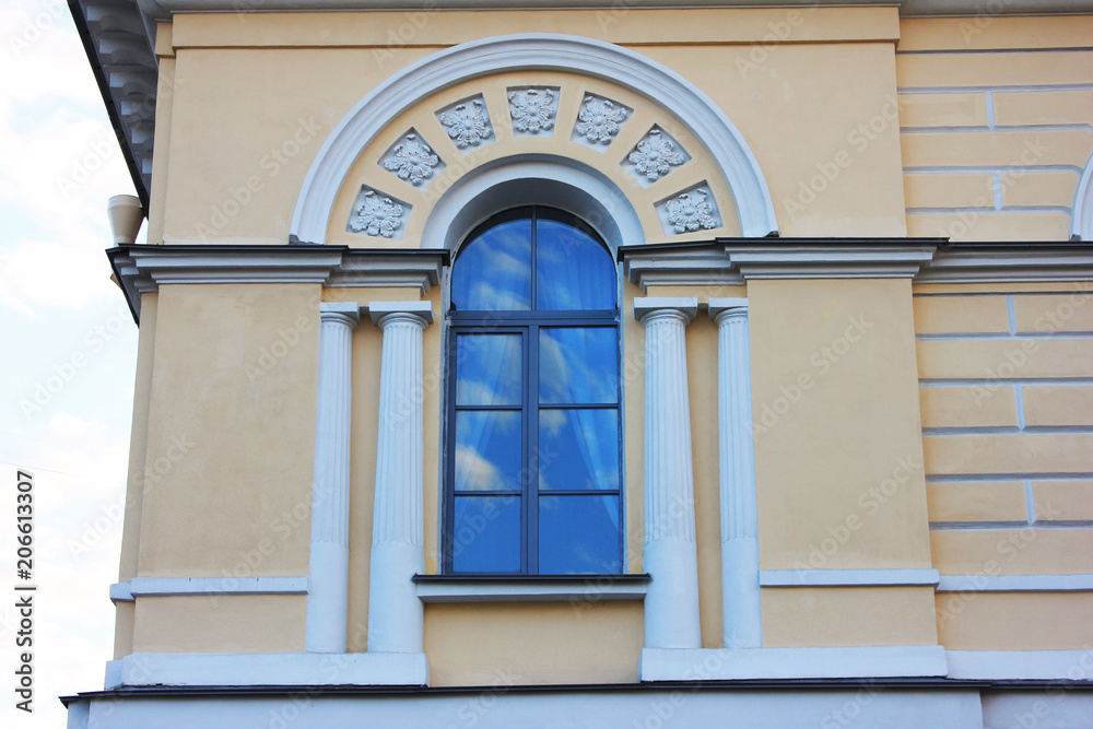 Window Archway Frame on Ornamental Facade Wall of Classical Building. Architecture Detail of Historic Decorative House Exterior of Minimalistic Windows with Small Pillars against Sky Background.