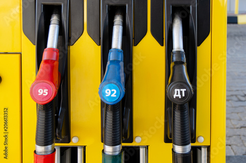 Colorful petrol pump filling nozzles, Gas station in a service photo