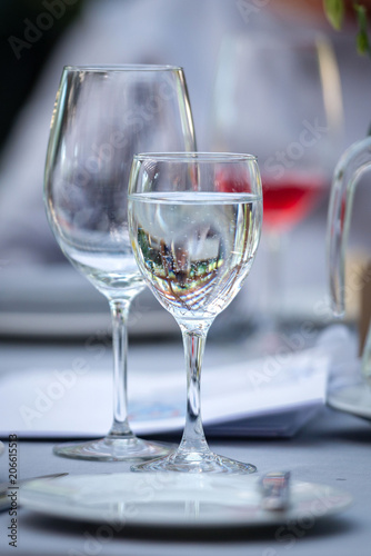 Table laying concept. On the table there are glasses and a mug with drinking water.