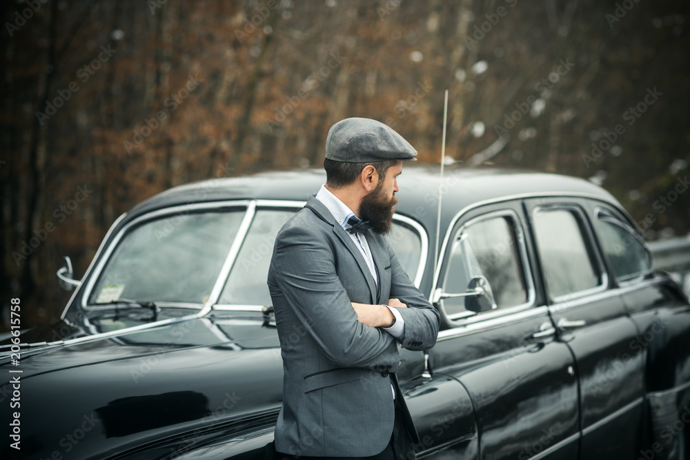 Call boy in vintage auto. Bearded man in car. Travel and business trip or  hitch hiking. Retro collection car and auto repair by mechanic driver.  Escort man or security guard Stock Photo |