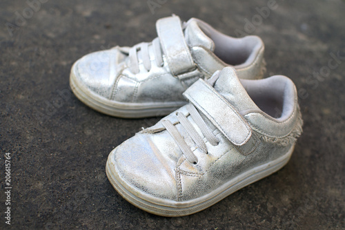  children's shoes on the asphalt