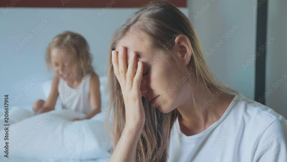 Upset mother with angry little child screaming pillow on the background Upset mother with angry little child screaming pillow on the background