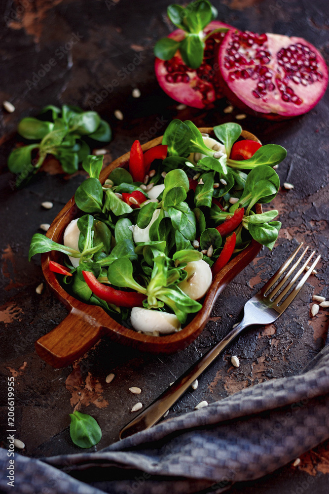Vegetarian salad in a wooden plate Vegetarian salad in a wooden plate