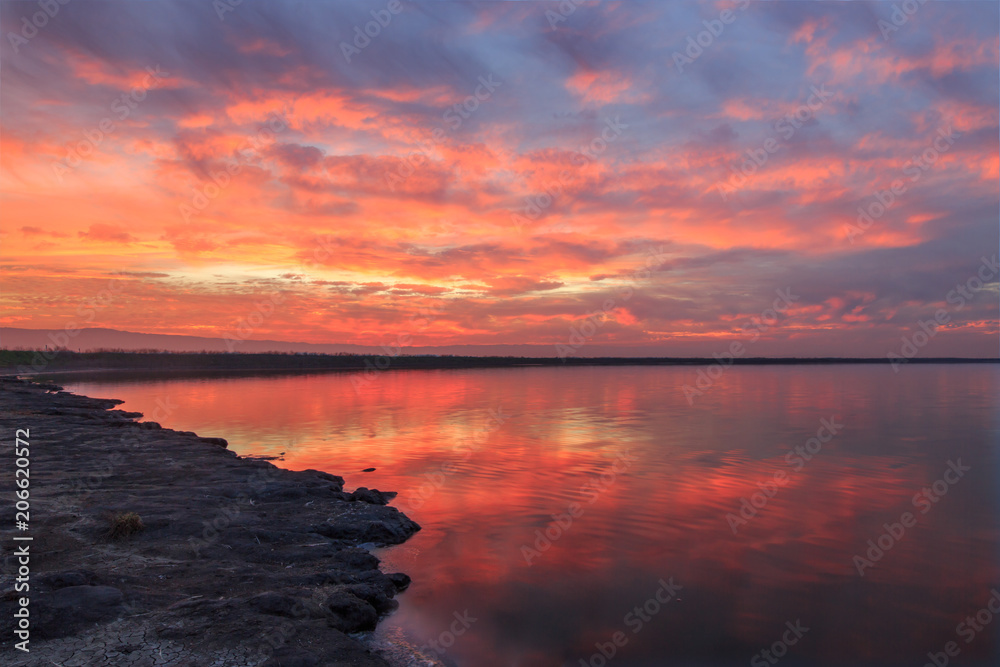 Winter Fiery Sunset in San Francisco Bay. Alviso Marina County Park, Santa Clara County, California, USA.