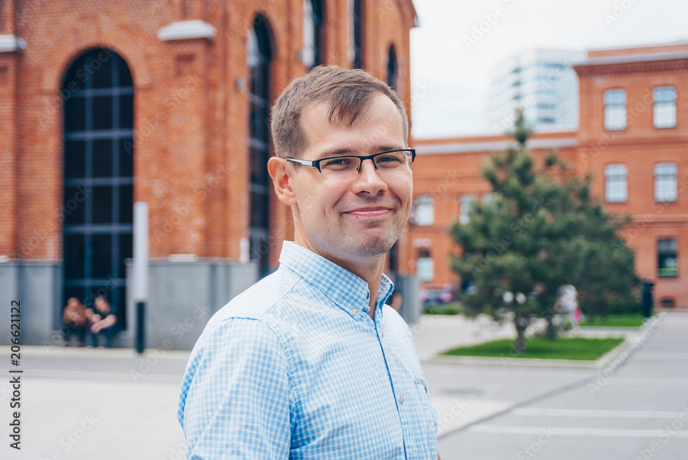 Fototapeta premium Portrait of attractive european guy in casual shirt and glasses