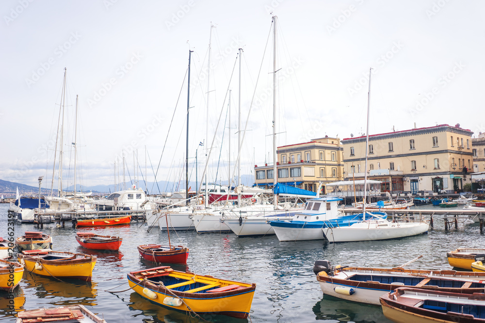 Fishermen boats and yachts in Borgo Marinari, harbor of Megaride island in Naples, Campania, Italy, Europe