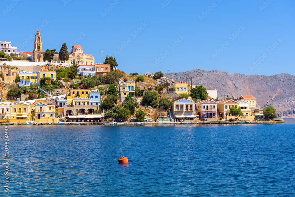 Beautiful bay and architecture of Symi island in sunny summer day. Greece