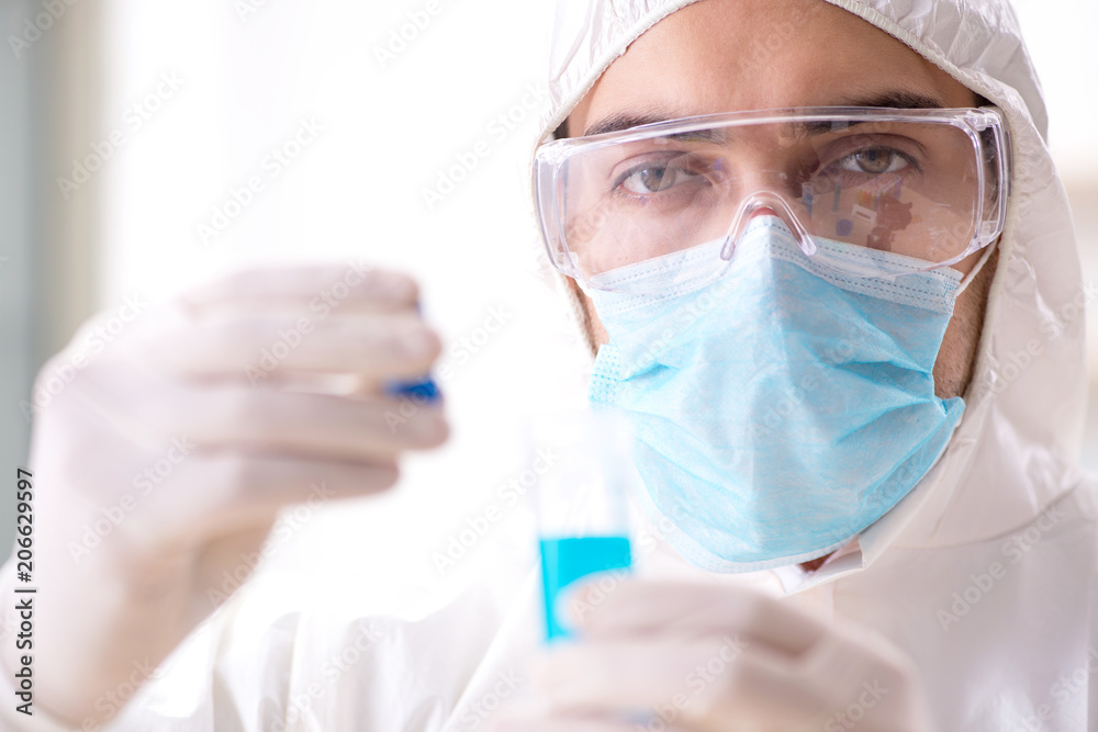 Young chemist student working in lab on chemicals Young chemist student working in lab on chemicals