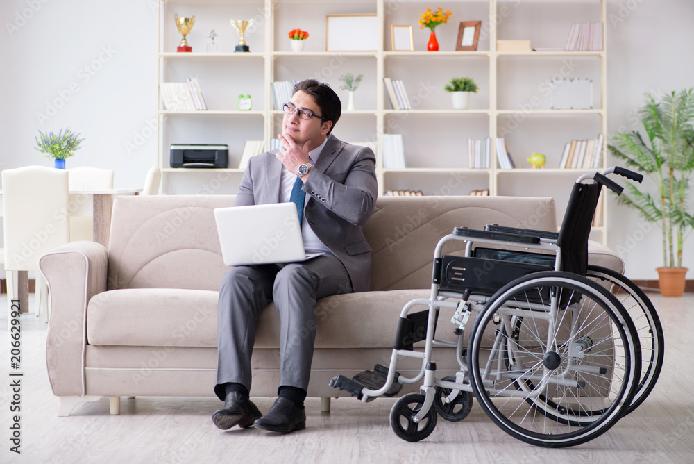 Dsabled businessman on wheelchair working home Dsabled businessman on wheelchair working home