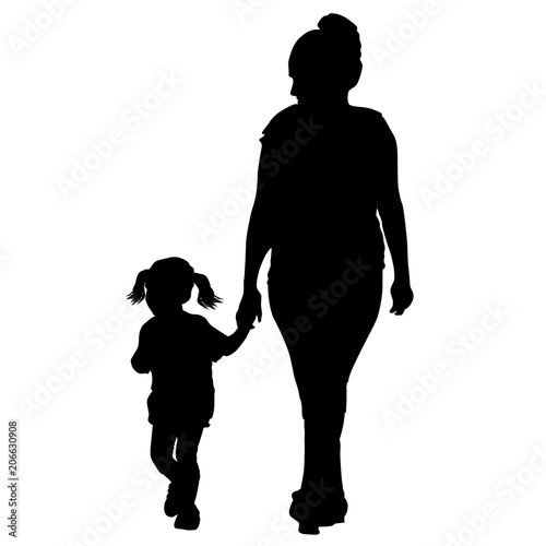 Silhouette of a mother walking by the hand with little daughter