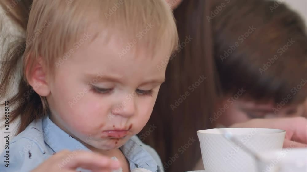 Cute little baby boy eating chocolate croissant Cute little baby boy eating chocolate croissant
