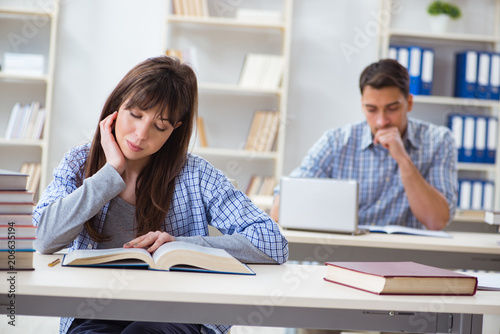 Students sitting and studying in classroom college