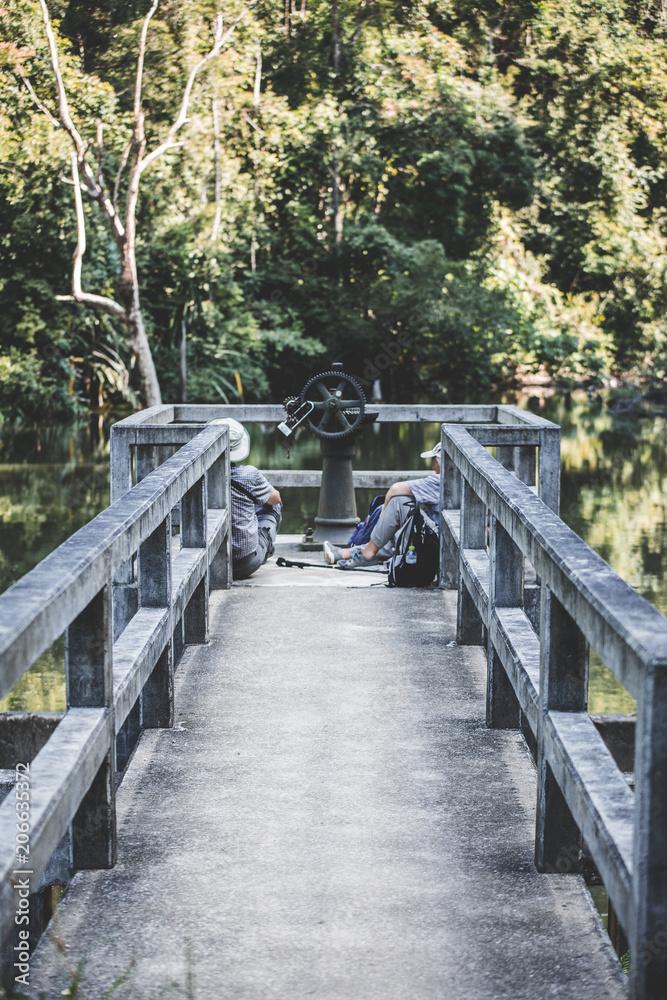 Two travelers resting on the pier