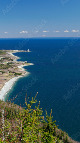 Cap-des-Rosiers lighthouse viewed from atop Mont Saint-Alban in Forillon National Park, Canada.