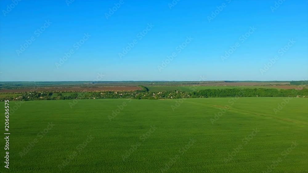 boundless green rice field against distant village by pictorial hills. boundless green rice field against distant village by pictorial hills.