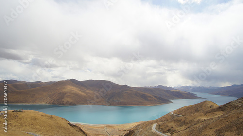 Mountain with some cloud on the blue clear sky and the river