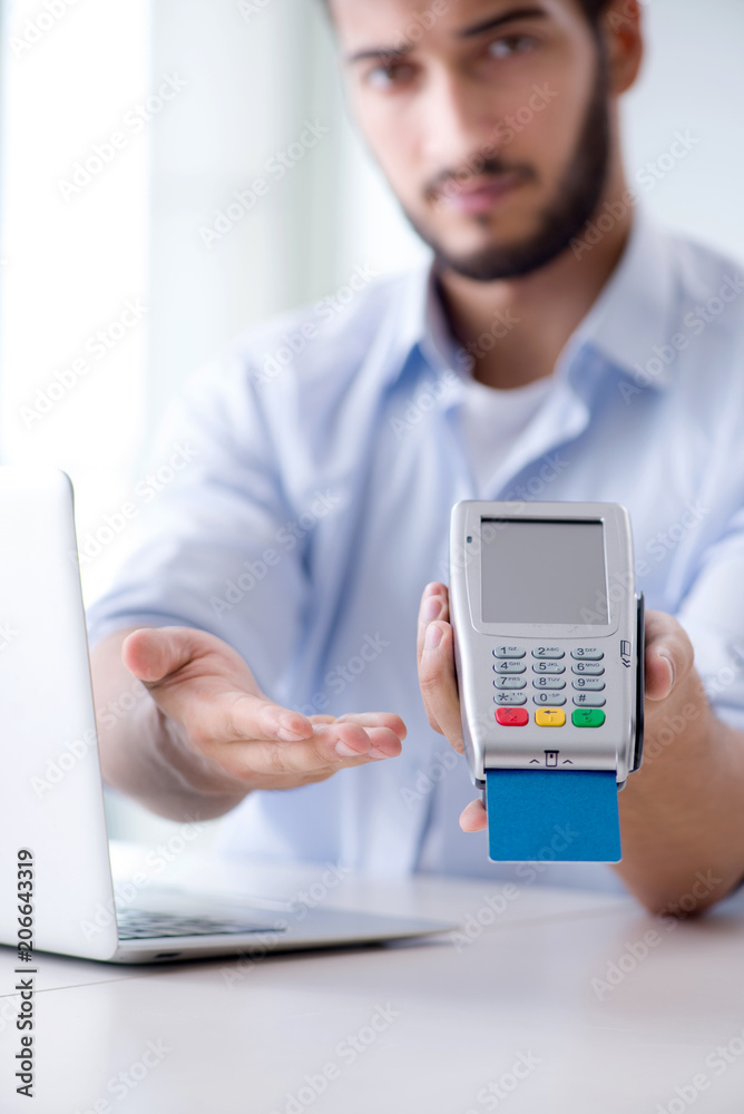 Man processing credit card transaction with POS terminal Man processing credit card transaction with POS terminal