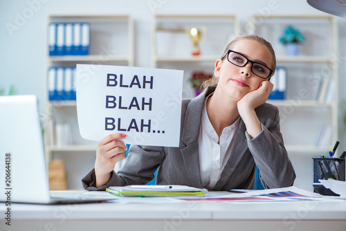 Businesswoman sitting in office with message