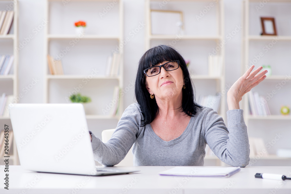 Senior woman struggling at computer Senior woman struggling at computer