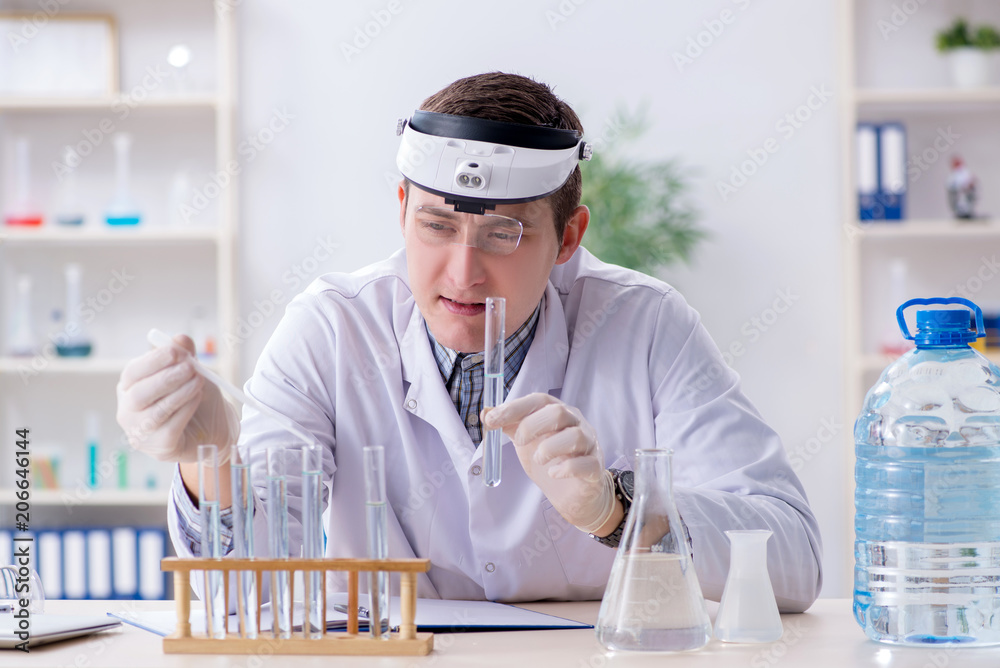 Young chemist student experimenting in lab