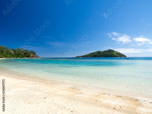 Beautiful Landscape of Reef and Turquoise Aqua Blue Clear Ocean Water with White Sand Beach and Palm Trees on Tropical Pacific Island of Fiji