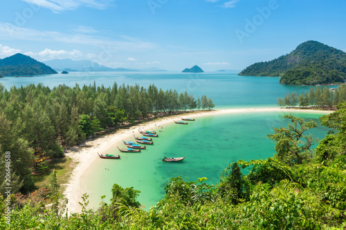 White sand beach and Long-tail boat at Kham-Tok Island (koh-kam-tok), The beautiful sea Ranong Province, Thailand. photo