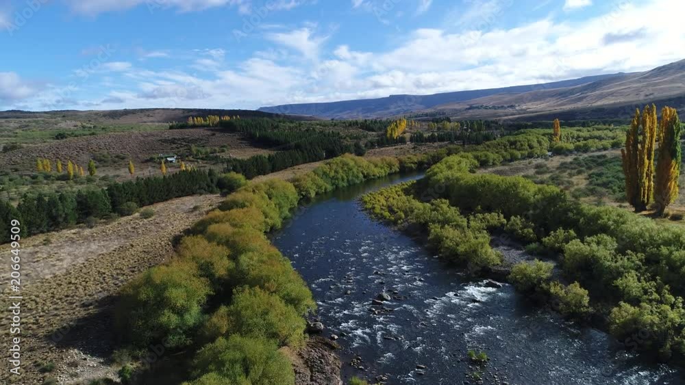 Aerial drone scene of Pulmari river with rocks, steppe, mountains and yellow trees in autumn and willow tree, road and a truck Camera moving forwards. Aerial drone scene of Pulmari river with rocks, steppe, mountains and yellow trees in autumn and willow tree, road and a truck Camera moving forwards.