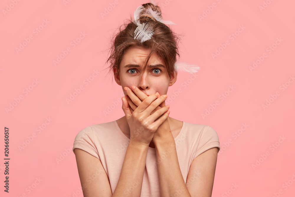 Photo of surprised sleepy female covers mouth and looks scared, overslept work, starts day with unpleasant news, dressed in nightwear, isolated on pink background. Omg, it`s already too late Photo of surprised sleepy female covers mouth and looks scared, overslept work, starts day with unpleasant news, dressed in nightwear, isolated on pink background. Omg, it`s already too late