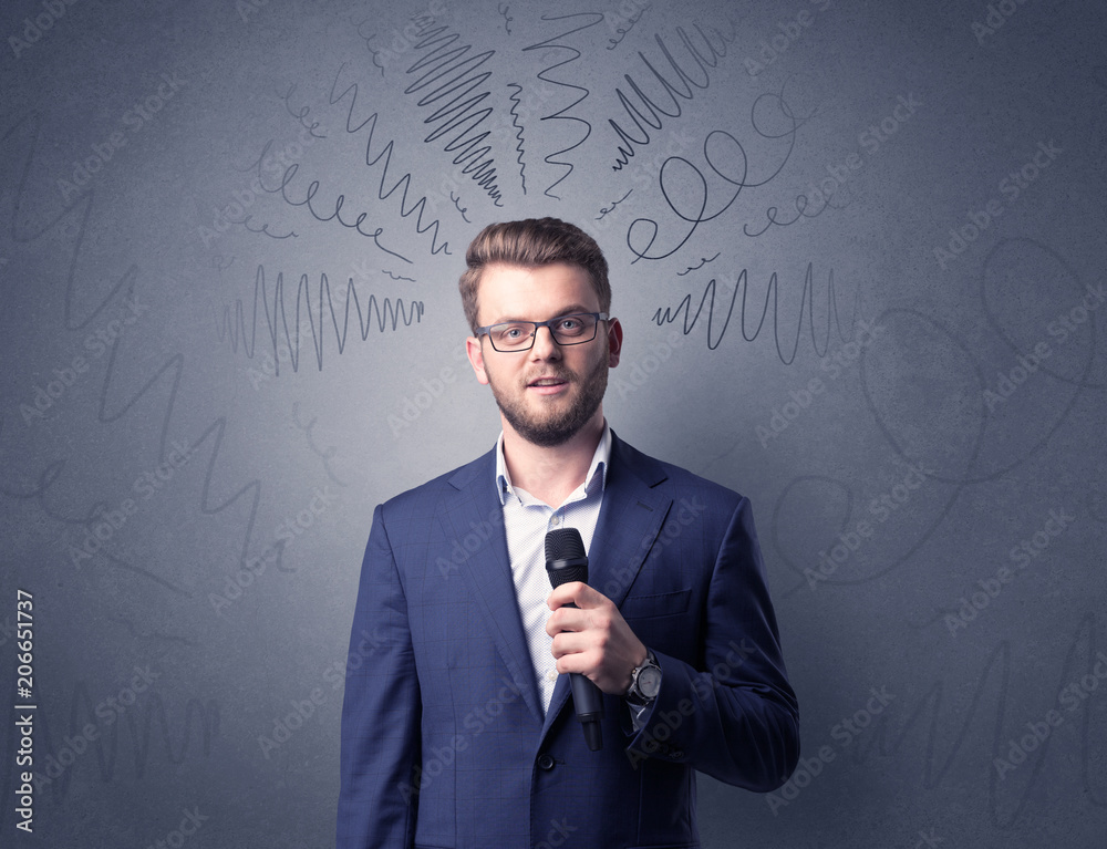 Businessman speaking into microphone with scribbles over his head Businessman speaking into microphone with scribbles over his head