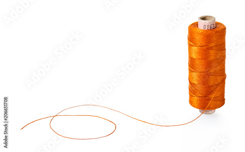 spool of orange threads photo