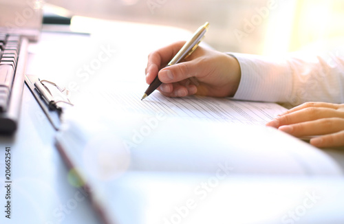 Businesswoman hands pointing at business document.