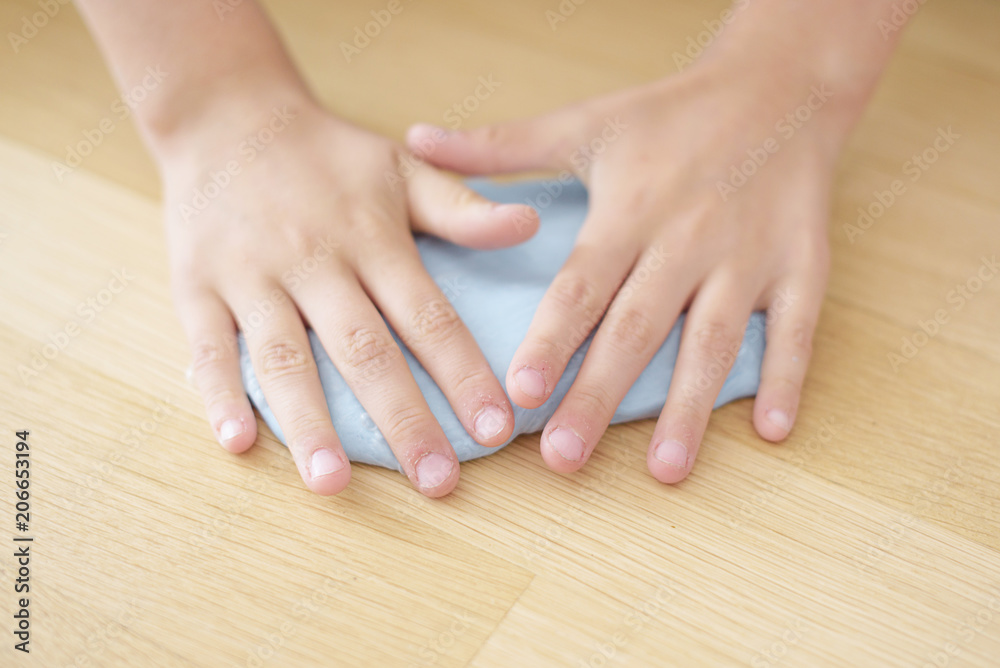 child playing hand made toy called slime. selective focus child playing hand made toy called slime. selective focus