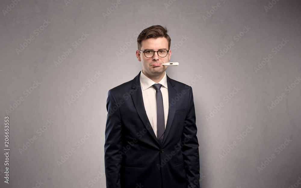 Young tired businessman with thermometer and copy space
Young tired businessman with thermometer and copy space