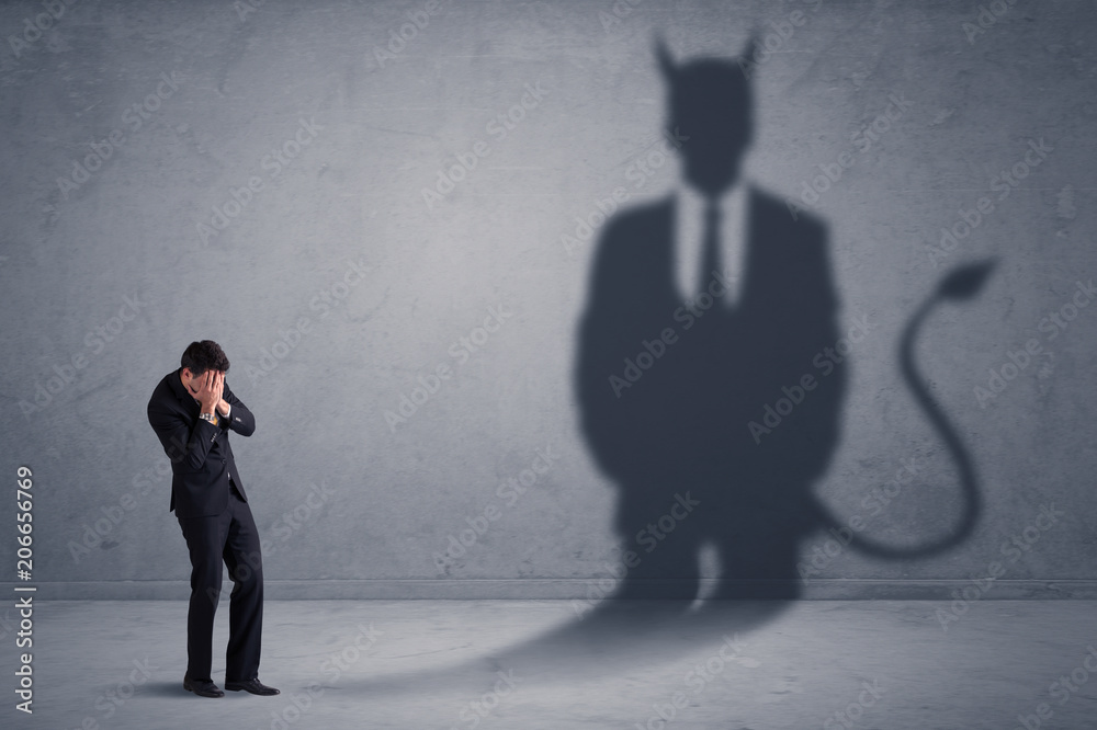 Fototapeta premium Business man looking at his own devil demon shadow concept background