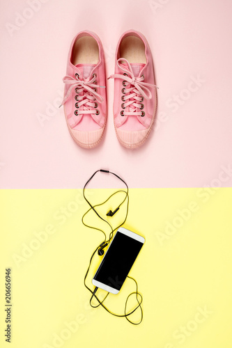 Pink canvas sneakers and mobile phone © Natalia Klenova