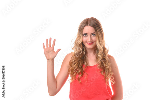 Young smiling blonde woman counting with fingers