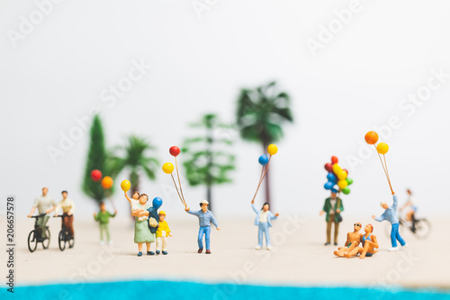 Miniature people : happy family enjoy summer vacation on the beach