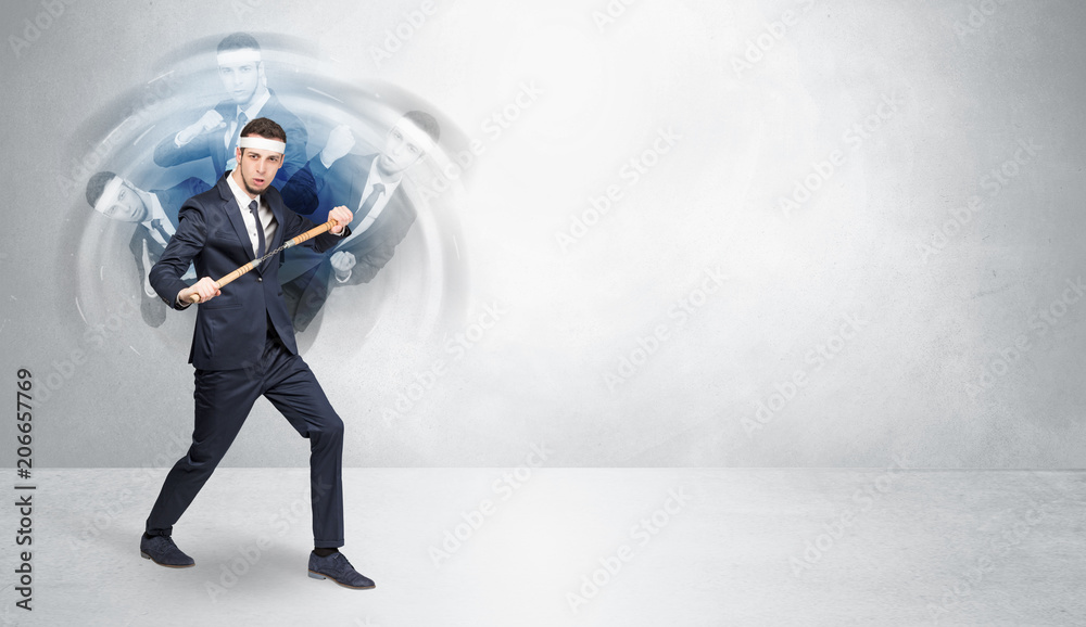 Young businessman in suit fighting with empty wall background
Young businessman in suit fighting with empty wall background
