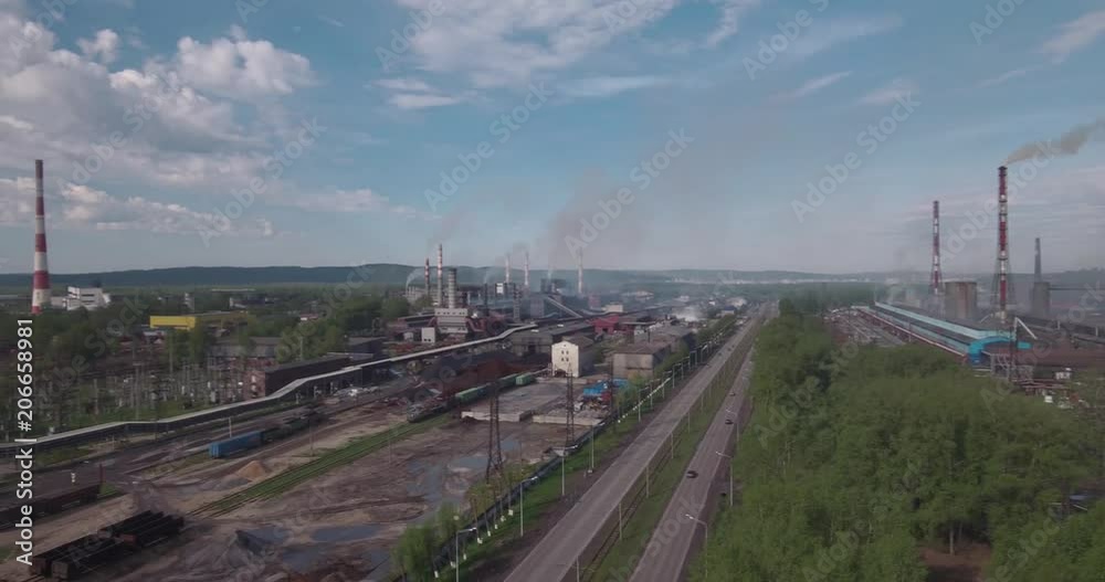 Top view, AERIAL: highway and industrial plant. Air pollution from industrial plants. Pipes throwing smoke in the sky. 4K