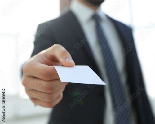 Business man giving business card on bright background