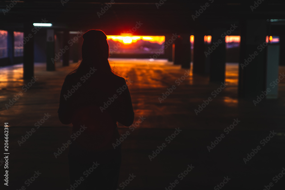 woman stand at car parking look on orange sunset