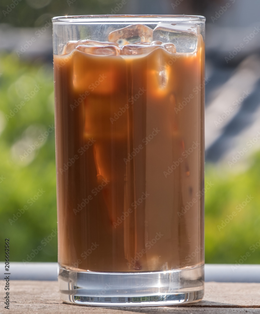 Iced milk coffee over wooden background Iced milk coffee over wooden background
