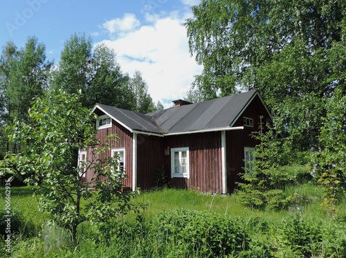 Old Finnish farm house standing empty on a summer day