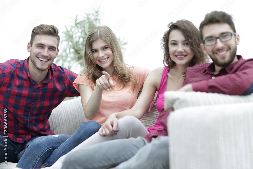 group of happy young people sitting on the couch