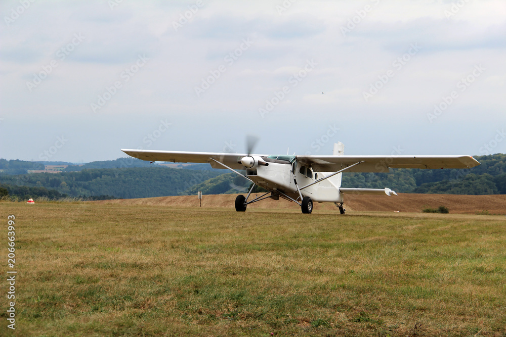 A small plane lands on the airfield