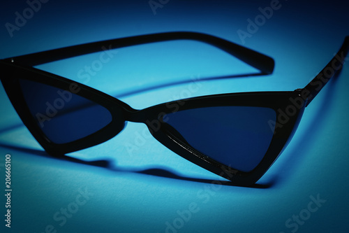 black sunglasses on a blue background