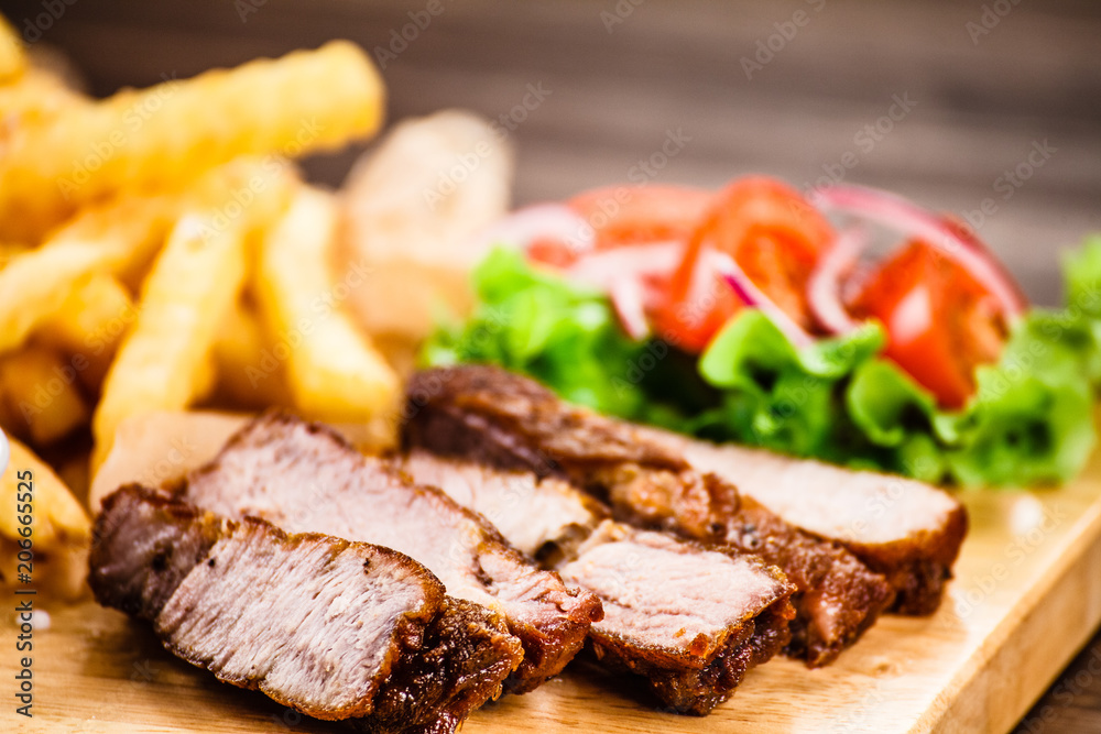 Grilled beefsteak with french fries and vegetables