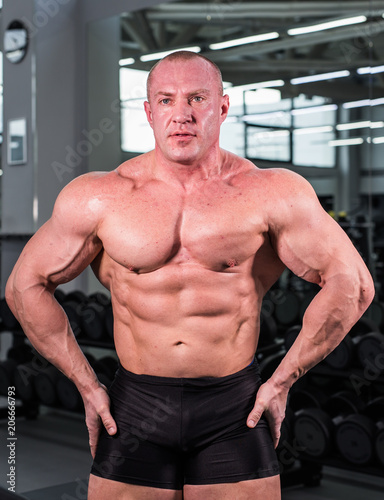Handsome bodybuilder man with big muscles in the gym