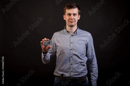 Young black haird man houlding credit card in his hands photo