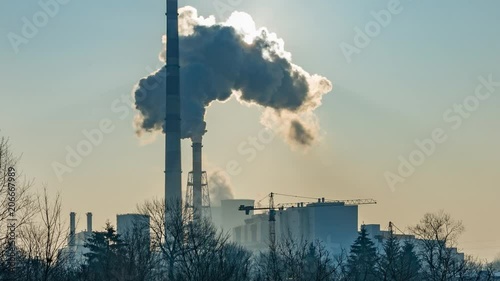 Power plant smoking chimneys and sun time lapse photo